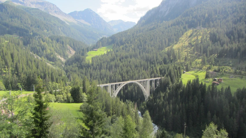 an aerial view of the bridge and mountains