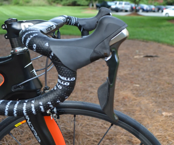 closeup of bike with dirt ground and grassy area in background