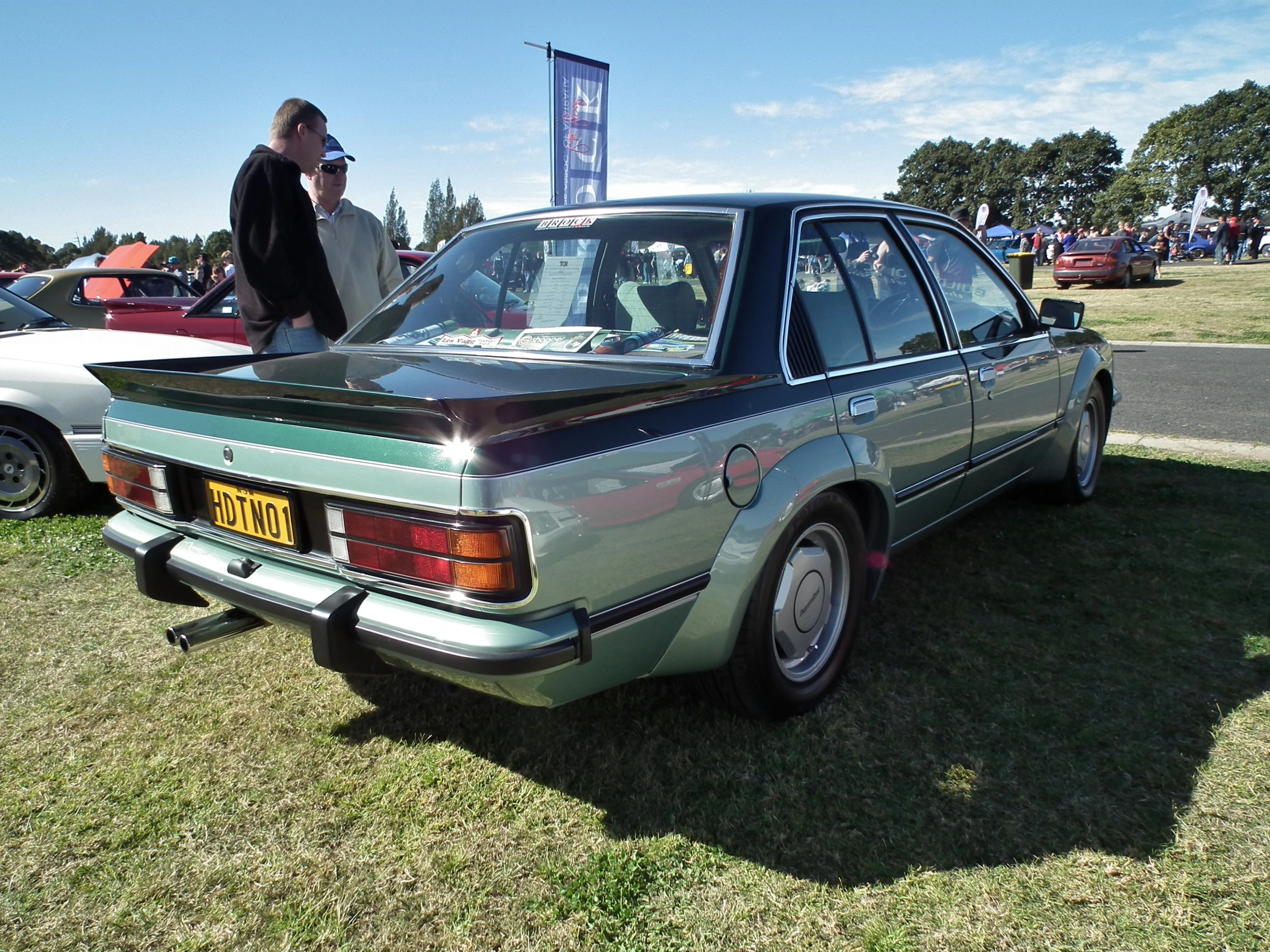 an old and very nice looking car in some grass