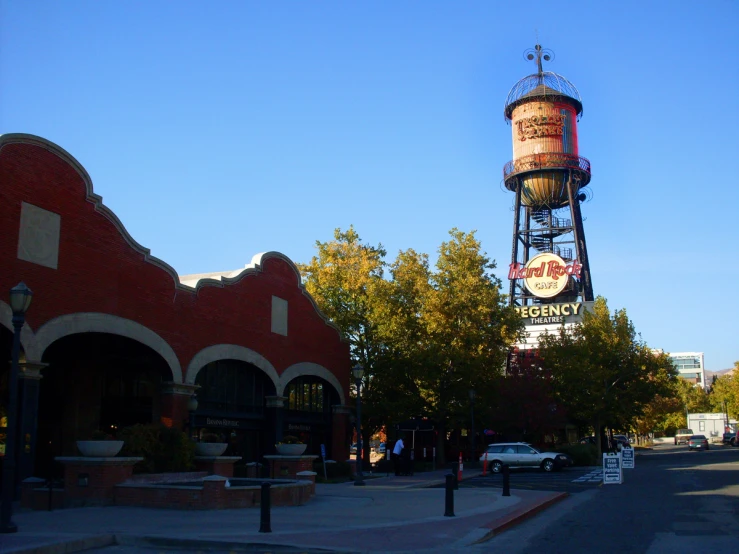 an old style water tower with a clock on it's side
