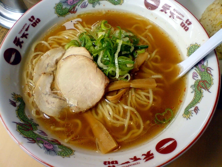 this bowl contains meat and noodles in broth