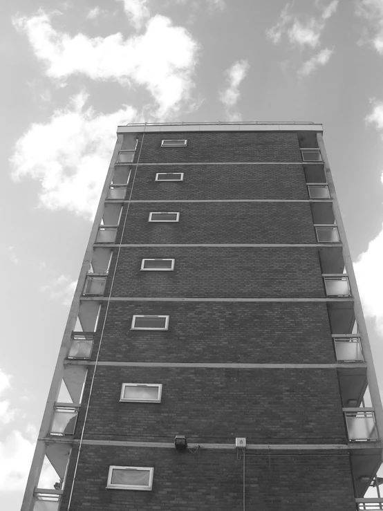 the bottom of a tall building with many windows