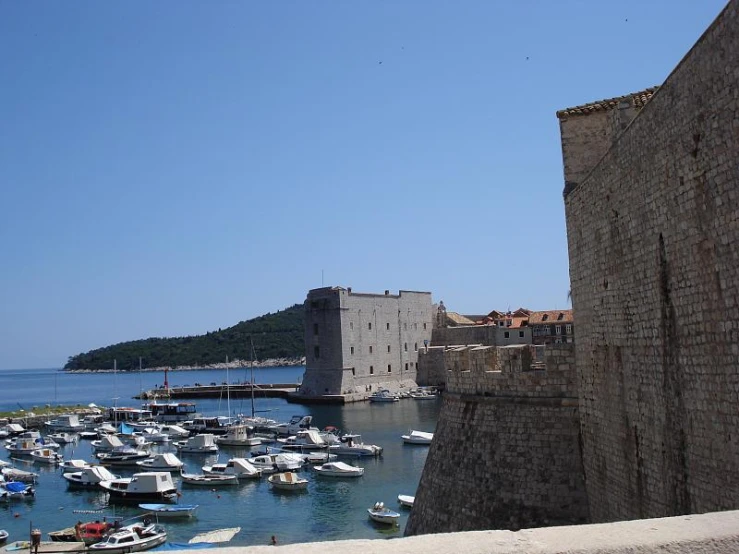 several boats are docked in the river next to buildings