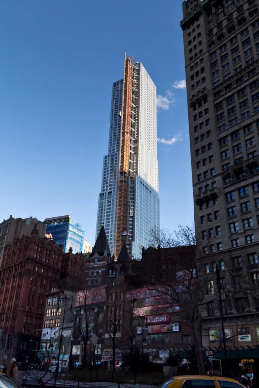 tall skyscrs towering over city at the top of them