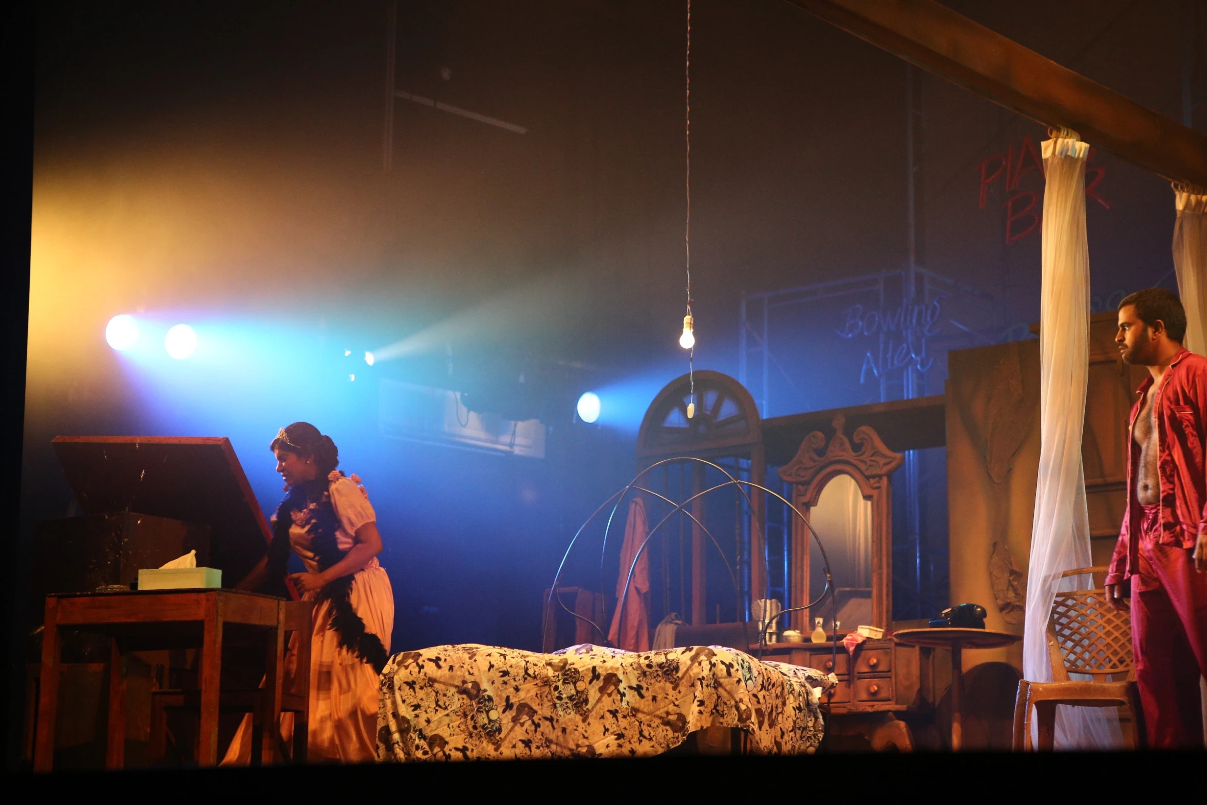 two people at the table on stage with a piano