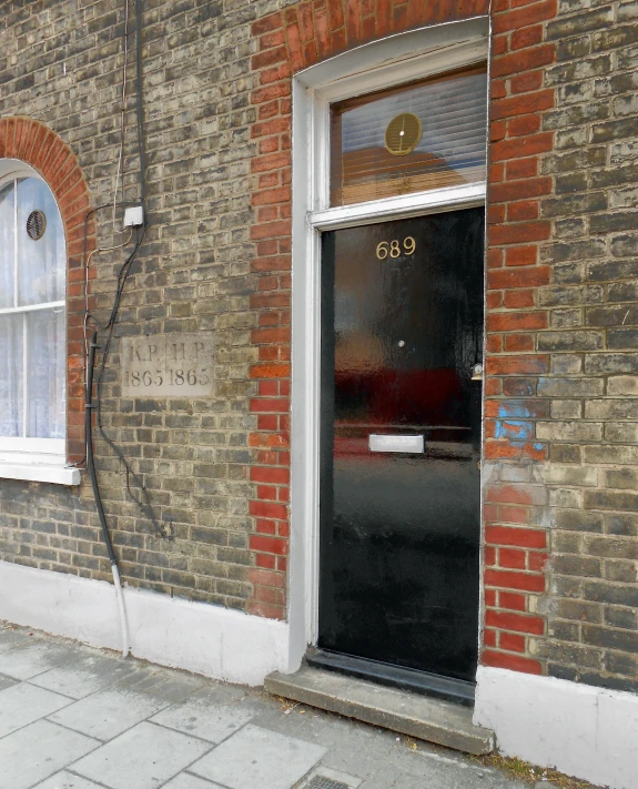 there is a black door on a brick building