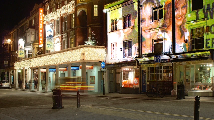 a city street with lights and various buildings