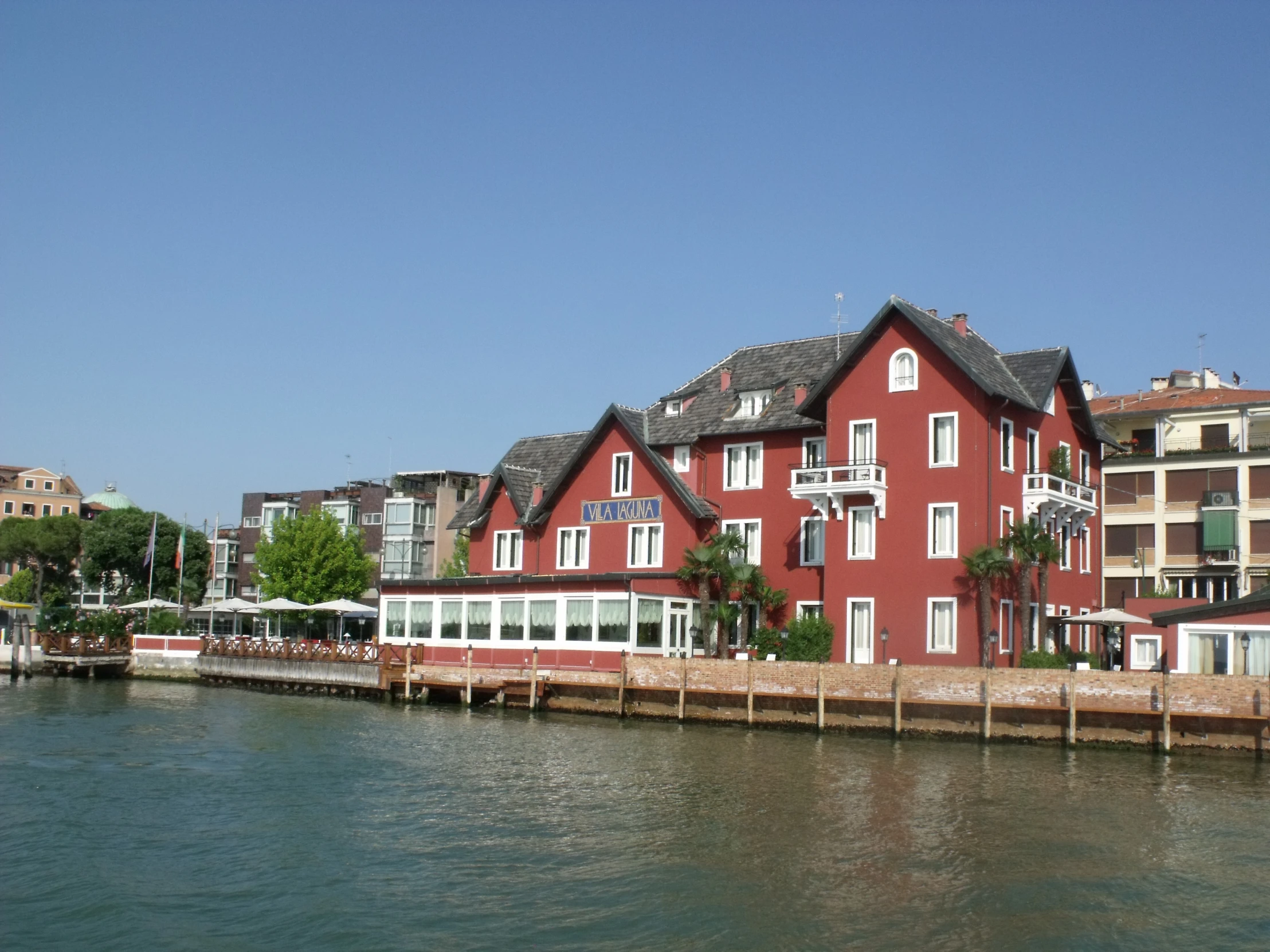 a very large red house sitting along the water