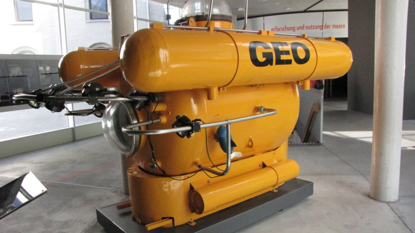 an orange industrial machinery is sitting on display