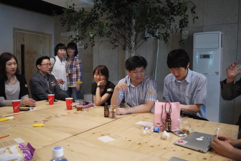 people sitting around the table eating and drinking