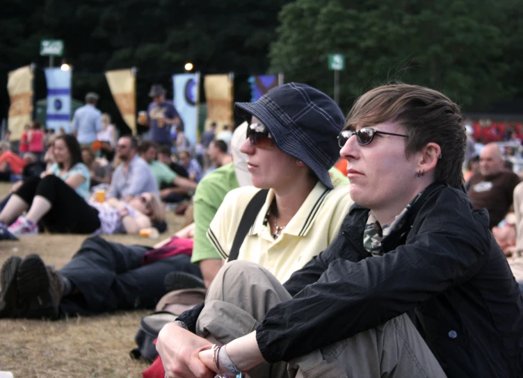 two people sitting together in front of a large crowd