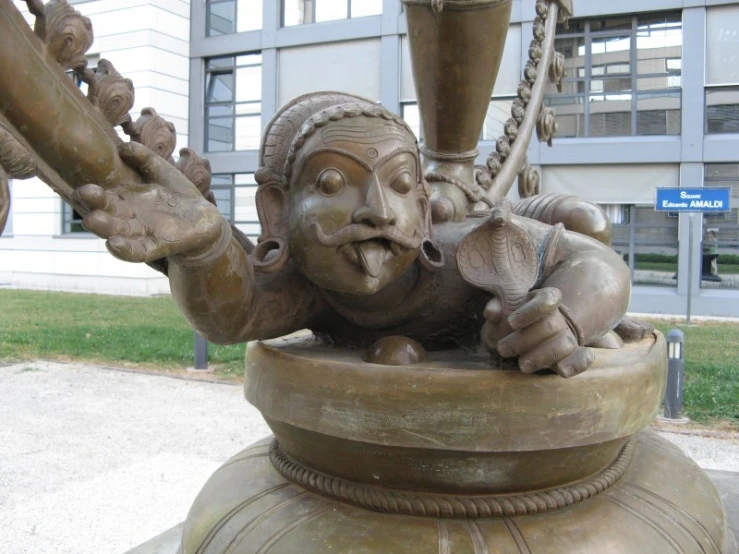 a statue of a woman swinging on a big chain