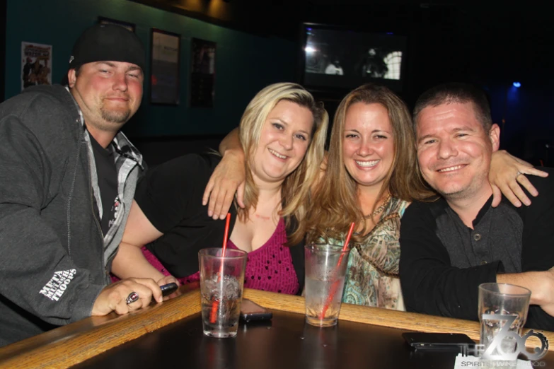 a group of people standing next to each other with drinks