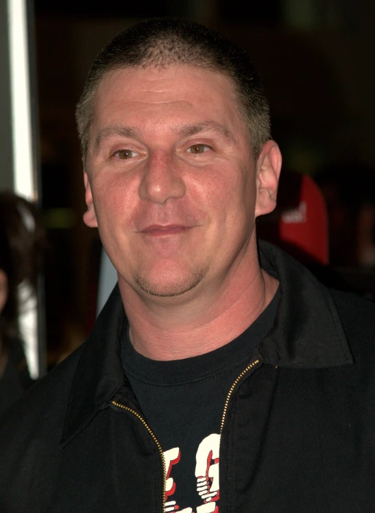 a man with a black shirt and a yellow collar around his neck