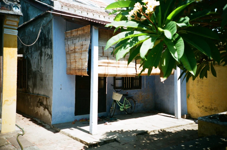 a blue building with a green bike next to it