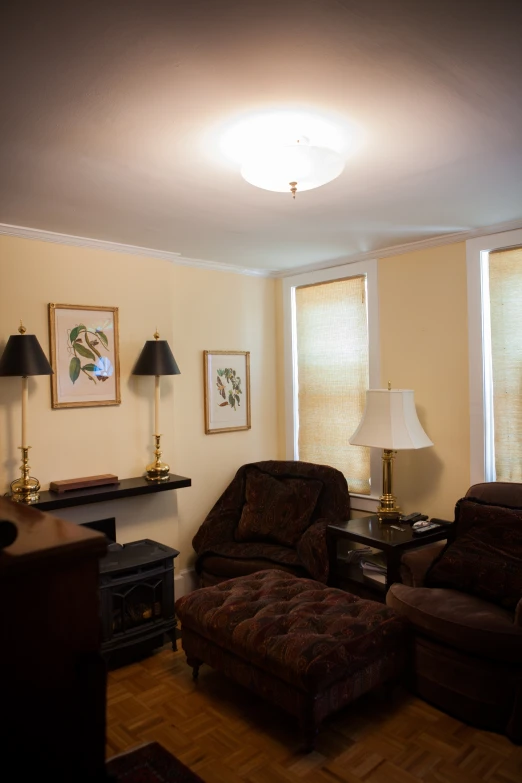 a living room filled with furniture under three large windows