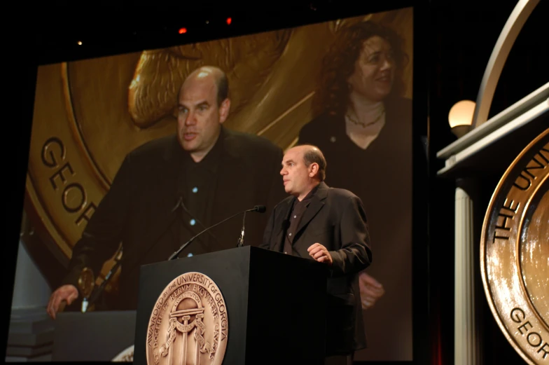 a man standing in front of a podium talking