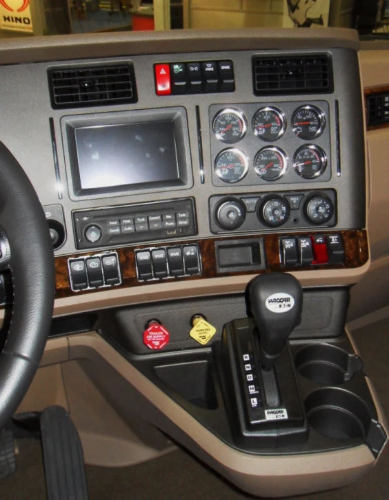 view from a dashboard showing dashboard controls and steering wheel