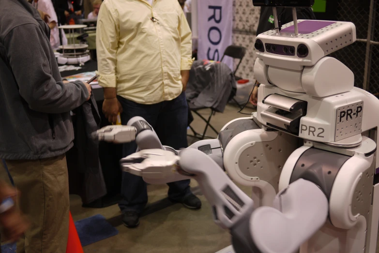 a person standing with some robots around him