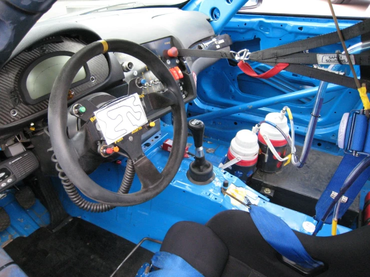 the inside of a car with several electronic devices in the driver seat
