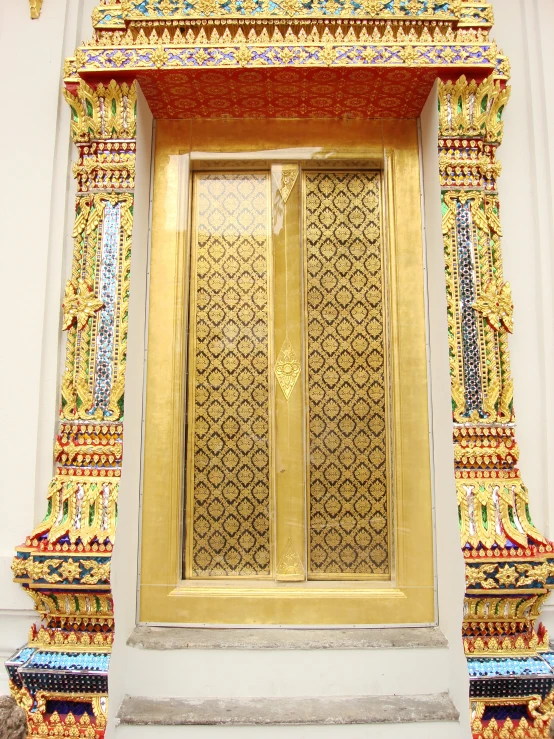 a golden doorway that is inside of a building