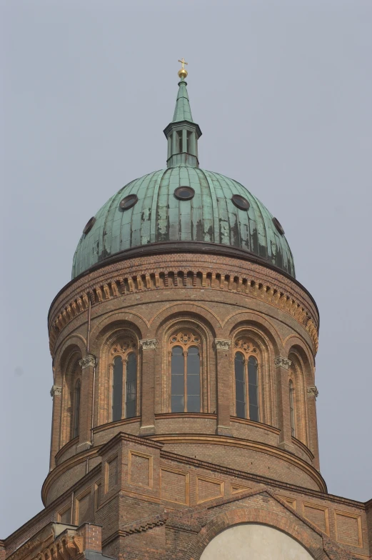a tower with a large green roof and circular top
