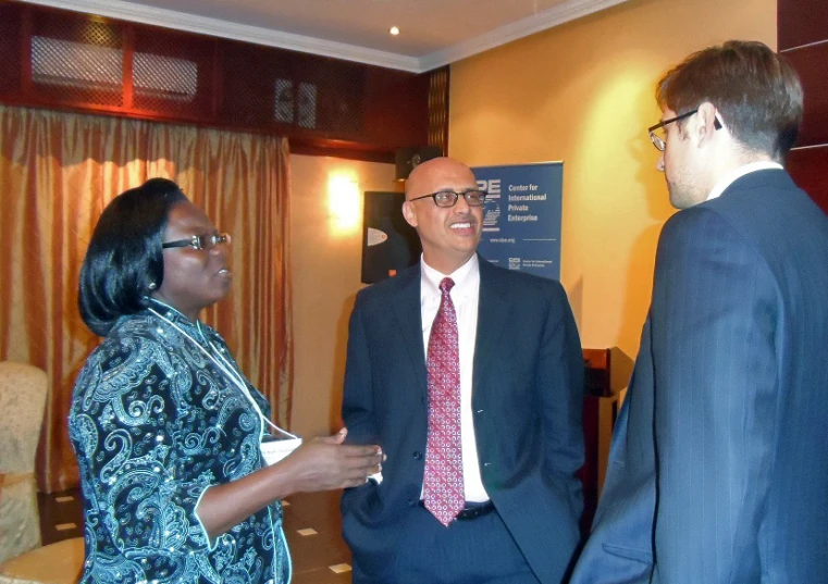 a man and woman wearing business attire talk to each other