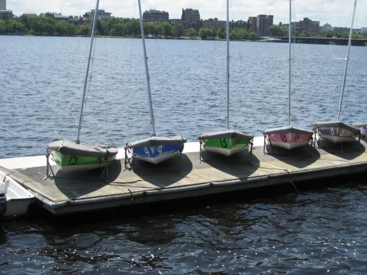 a group of small boats on a dock near the water