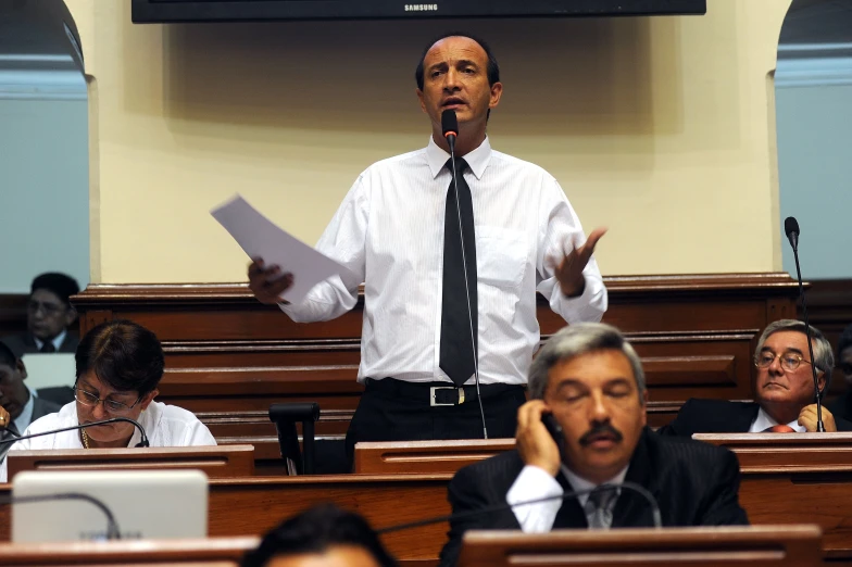 a man is shown addressing at an assembly