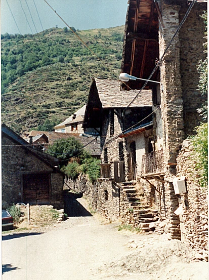 a street is lined with old buildings on the side of a hill