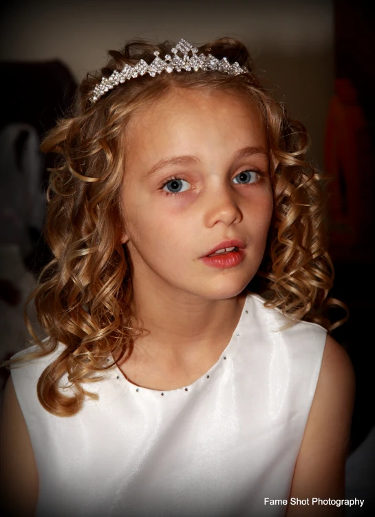 a close up of a  wearing a tiara