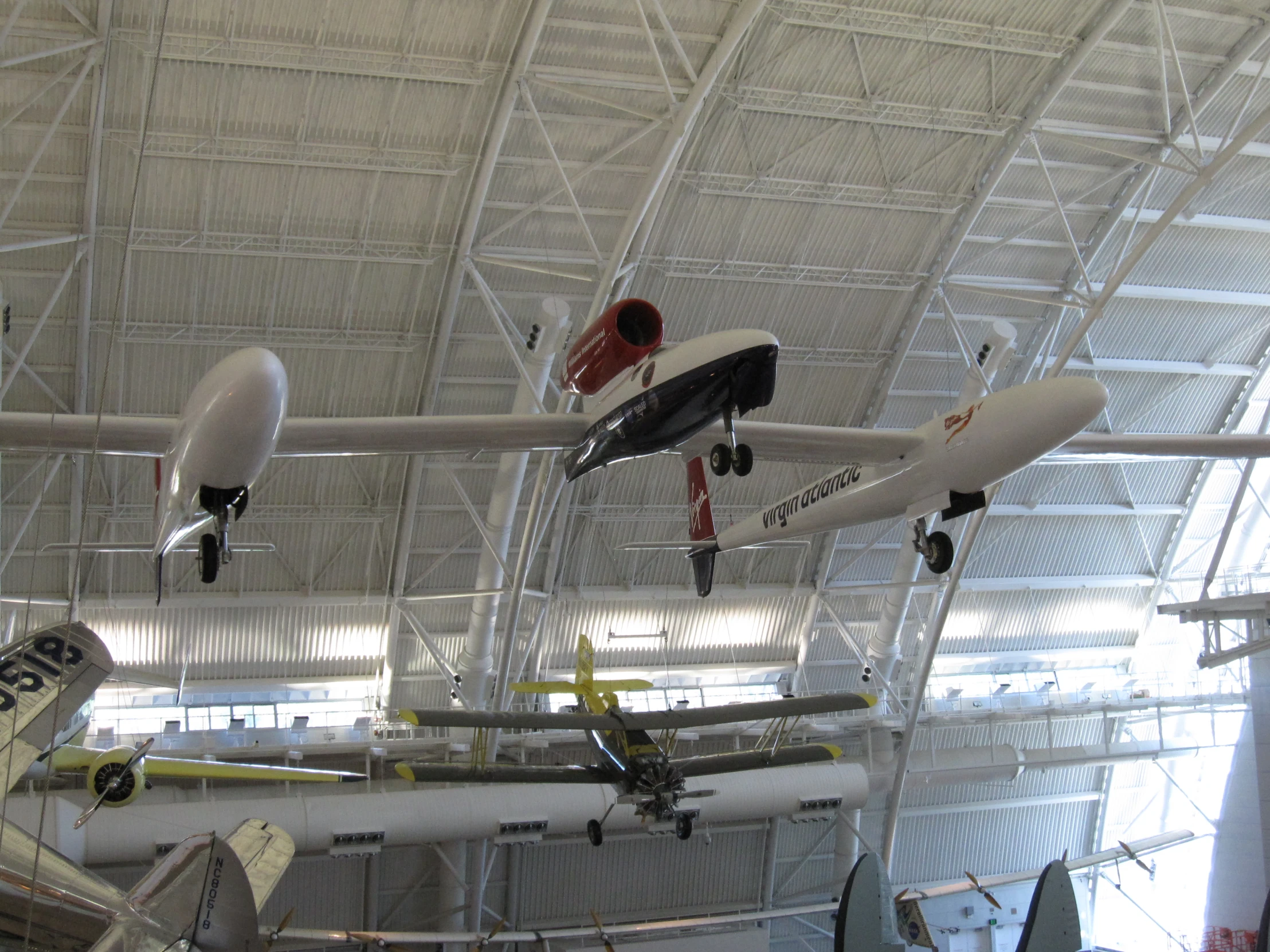 the three gliders are suspended from the ceiling in an airport