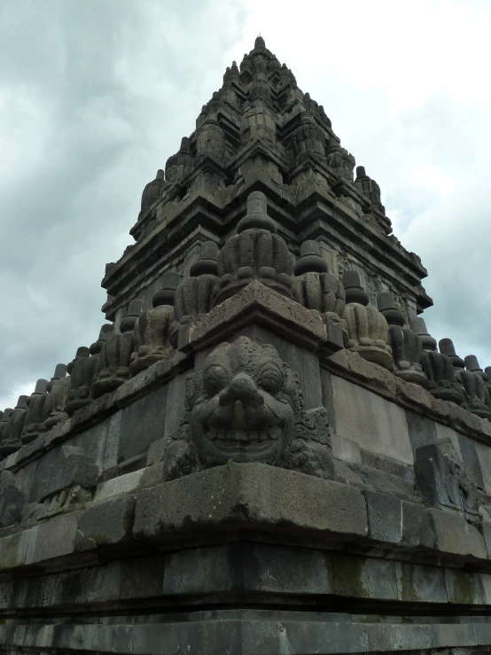 a tall stone pyramid with some statues on it