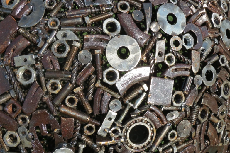 a pile of old metal pieces that are scattered on the ground
