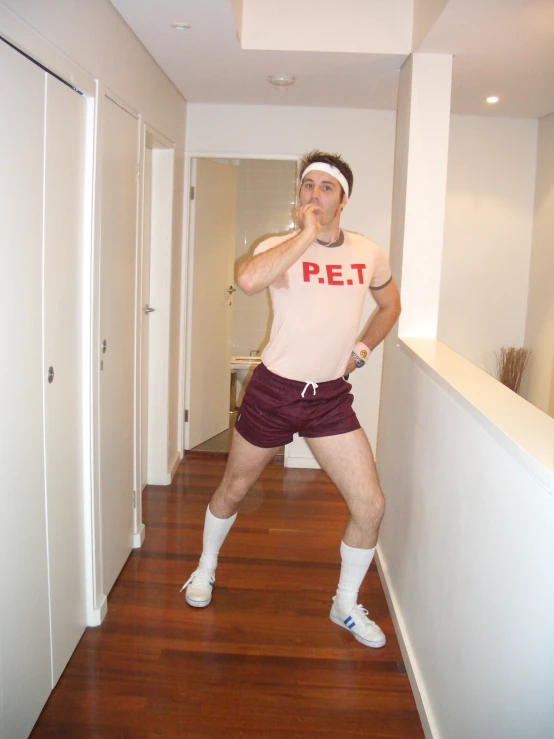 a man in a bathroom poses for a camera