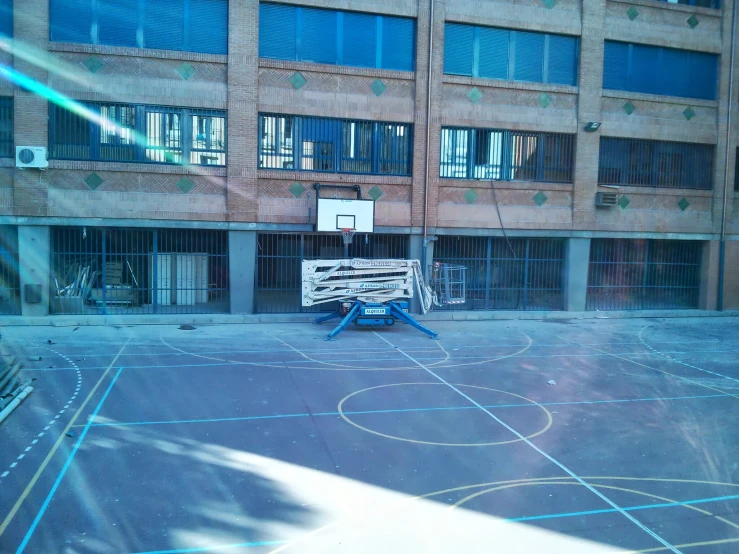 a basketball court in front of an empty building