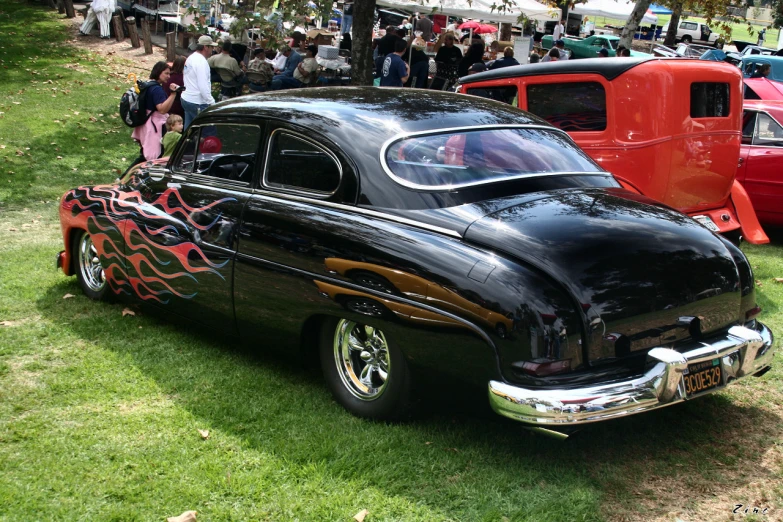 a black car with a dragon decoration sitting on it's tail end