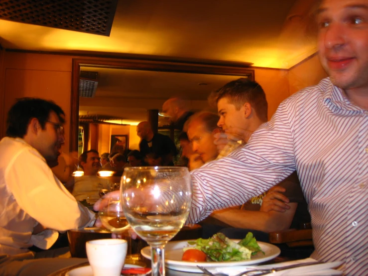 a man holding his hands out towards a plate of food