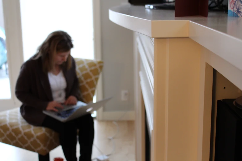 a woman sitting on a chair and looking at soing