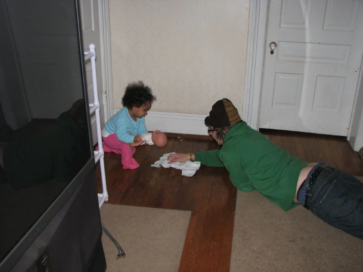 two people laying on the floor next to each other