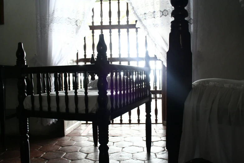 a bed room with a metal crib and white curtains