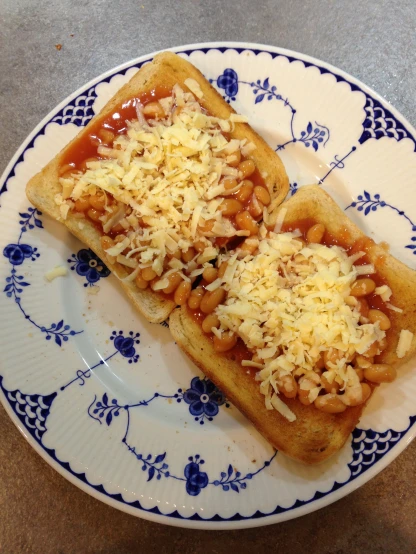 two french toasts on top of a plate topped with cheese