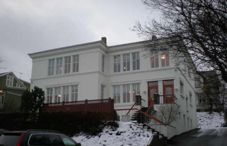 a large white home with a lot of snow on the ground