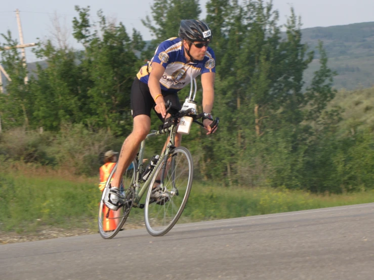 a man is racing a bicycle down the road