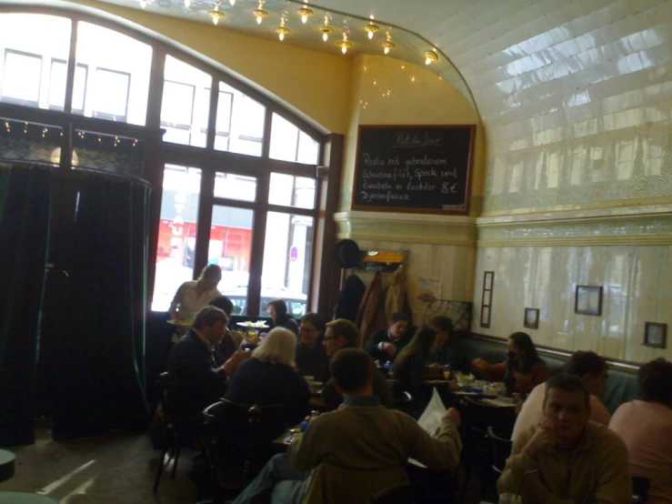 the restaurant area at a bar features tables and chairs