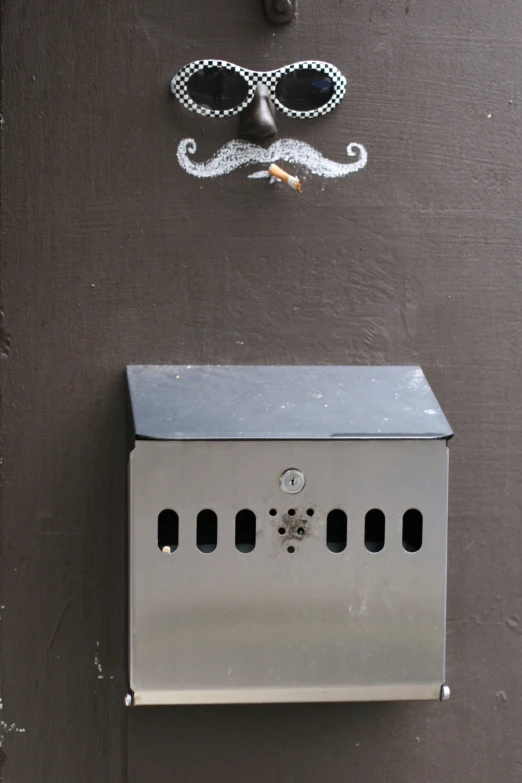 a mailbox has a paper mask attached to it