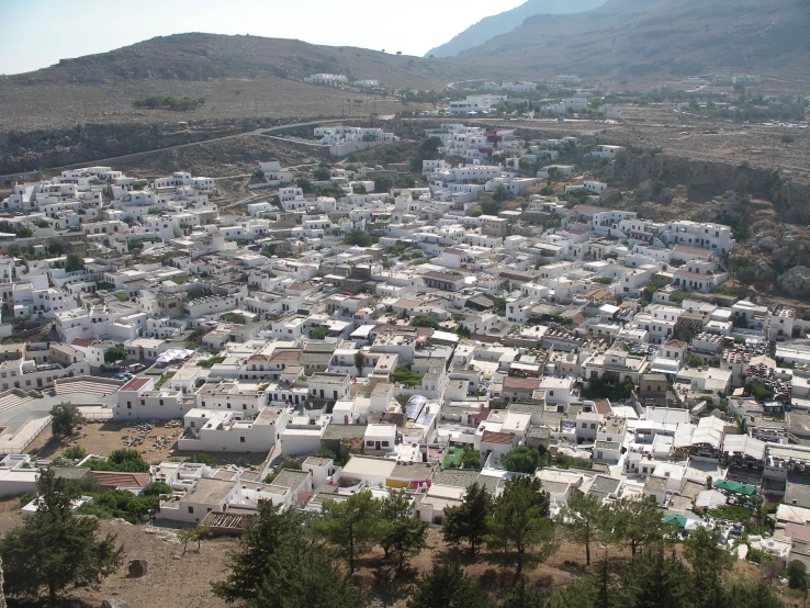 view from above of many white buildings in a hilly town