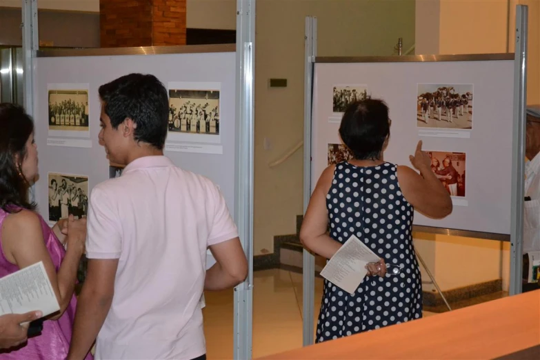 a group of people standing around a poster