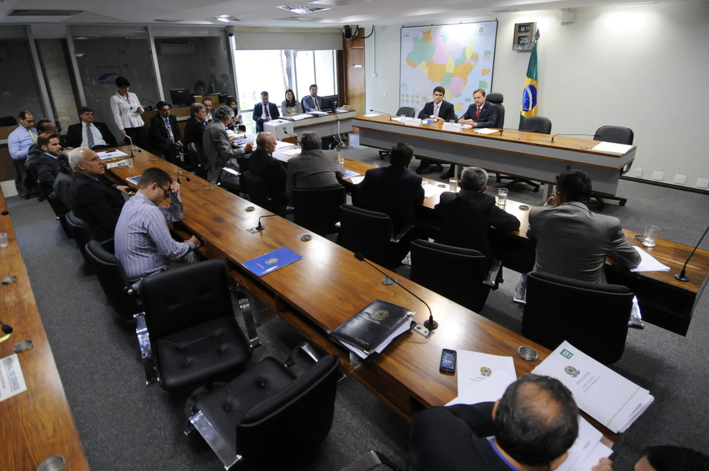 a man sitting at a long conference table