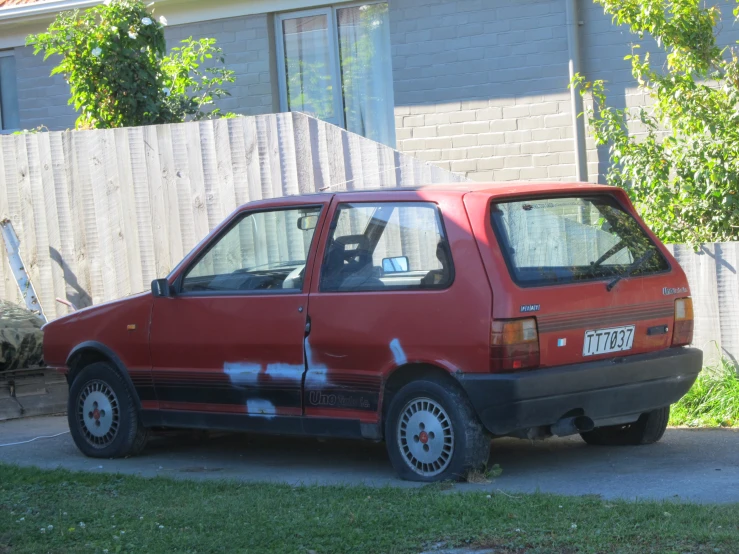 this car is parked on the side of a house